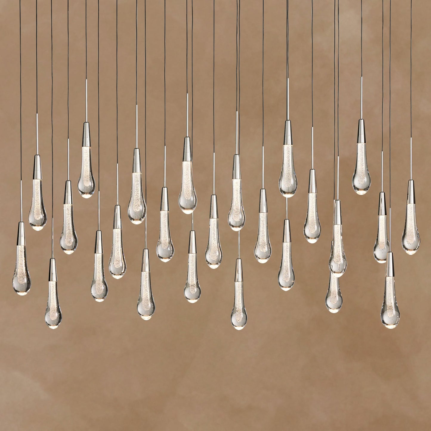 Chandelier with multiple hanging lampshades on a brown background